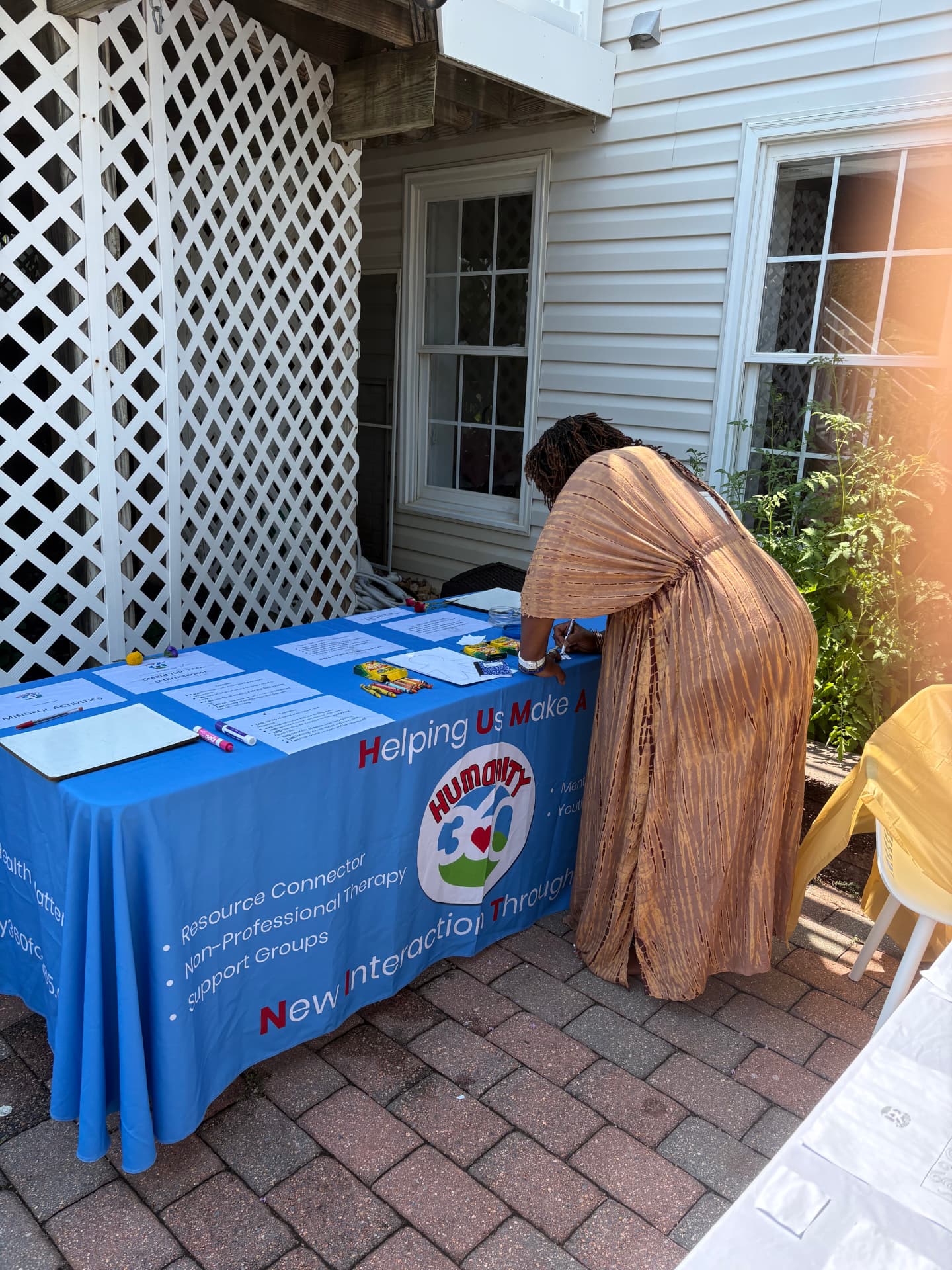 H.U.M.A.N.I.T.Y. 360 team members at the Joy Table with a sound bowl, cards, and resources